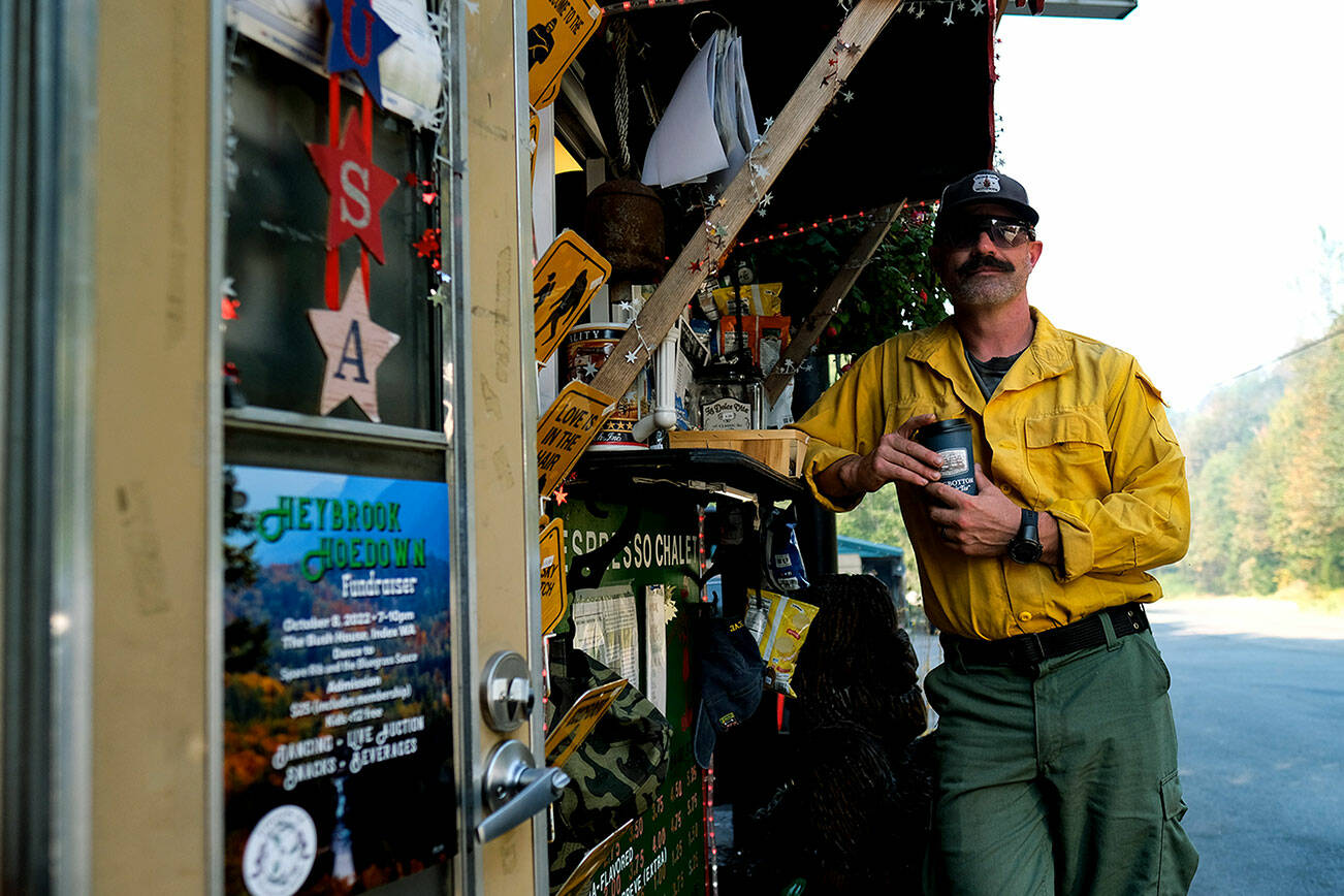 Dan Stucki grabs a free coffee from Espresso Chalet before heading out on his first day to assess the Bolt Creek Fire on Tuesday, Sept. 27, 2022. Stucki served as a division supervisor and traveled from Utah to help contain the fire. He's been a firefighter for 21 years. (Taylor Goebel / The Herald)