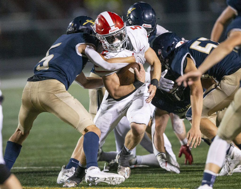 Stanwood’s Ryan Bumgarner runs through a tackle during the Stilly Cup against Arlington on Friday, Sept. 30, 2022 in Arlington, Washington. (Olivia Vanni / The Herald)
