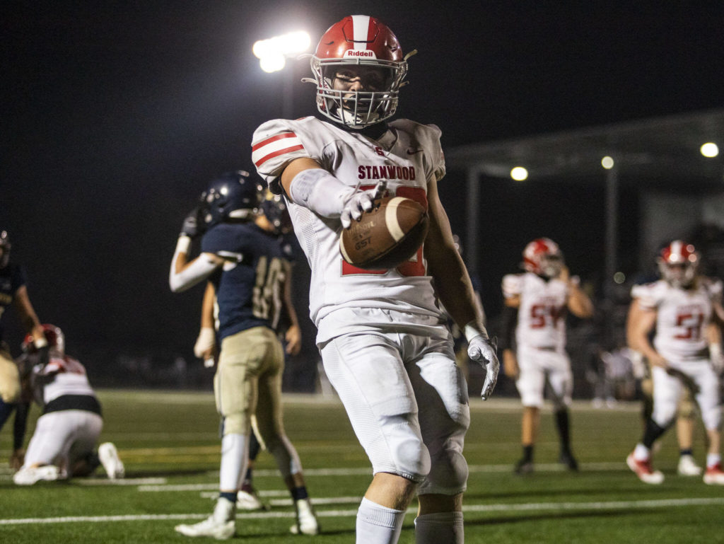 Stanwood’s Carson Beckt reacts after running into the end zone during the Stilly Cup against Arlington on Friday, Sept. 30, 2022 in Arlington, Washington. (Olivia Vanni / The Herald)
