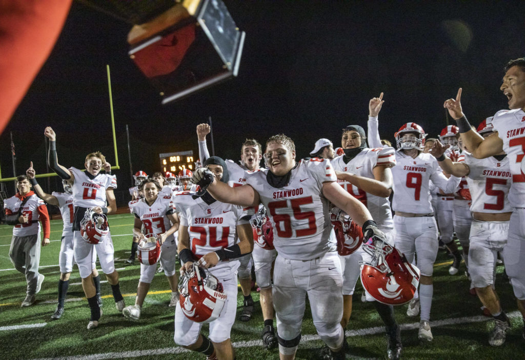 Stanwood players react to their coach bringing them the Stilly Cup on Friday, Sept. 30, 2022 in Arlington, Washington. (Olivia Vanni / The Herald)
