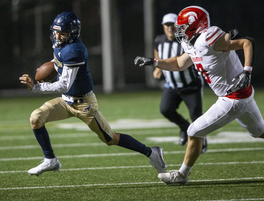 Arlington’s Leyton Martin runs the ball during the Stilly Cup against Stanwood on Friday, Sept. 30, 2022 in Arlington, Washington. (Olivia Vanni / The Herald)
