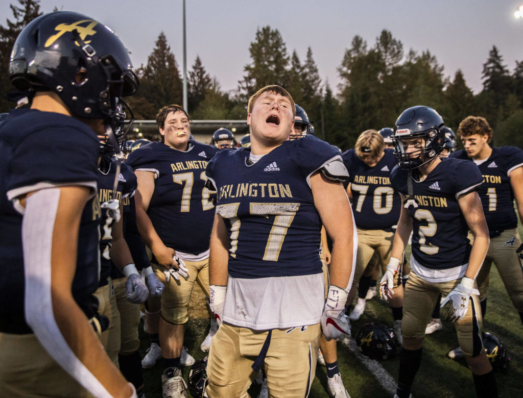 Arlington’s Wyatt Tilton gets his team pumped up before the the Stilly Cup against Stanwood on Friday, Sept. 30, 2022 in Arlington, Washington. (Olivia Vanni / The Herald)
