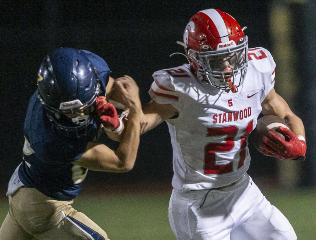 Stanwood’s Otto Wiedmann reacts out to block a tackle during the Stilly Cup against Arlington on Friday, Sept. 30, 2022 in Arlington, Washington. (Olivia Vanni / The Herald)
