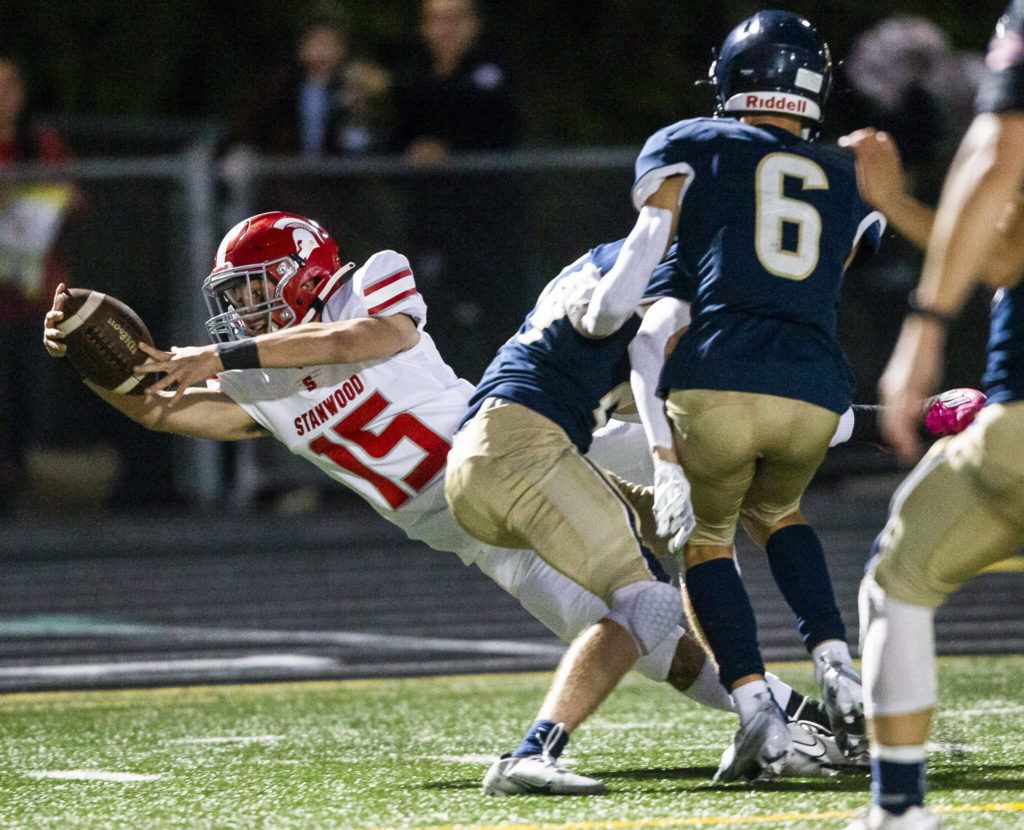 Stanwood’s Michael Mascotti reaches out to try and get a touchdown during the Stilly Cup against Arlington on Friday, Sept. 30, 2022 in Arlington, Washington. (Olivia Vanni / The Herald)
