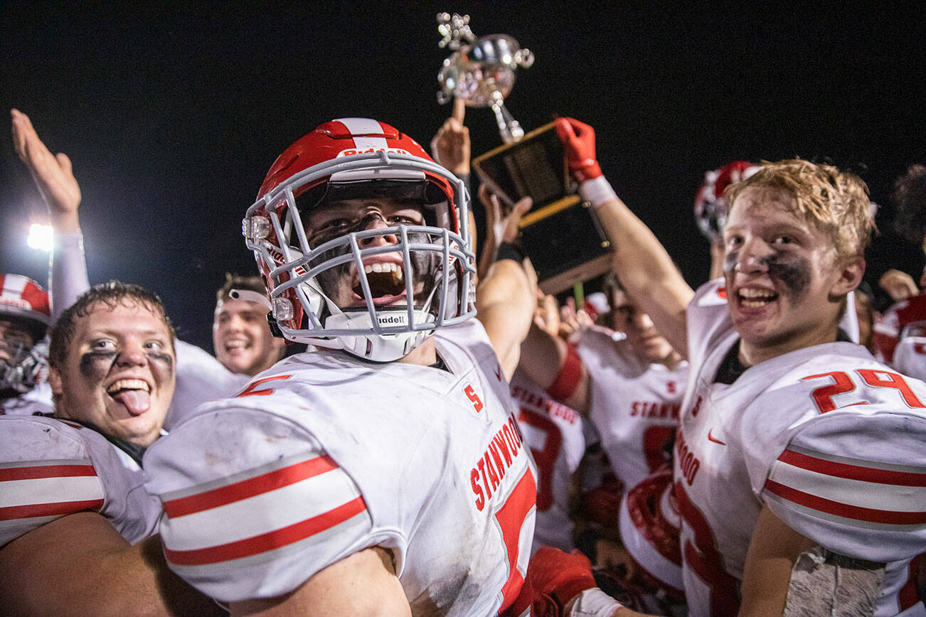 Stanwood’s Ryder Bumgarner and teammates yell in celebration after winning the Stilly Cup for the first time in 13 years on Friday, Sept. 30, 2022 in Arlington, Washington. (Olivia Vanni / The Herald)