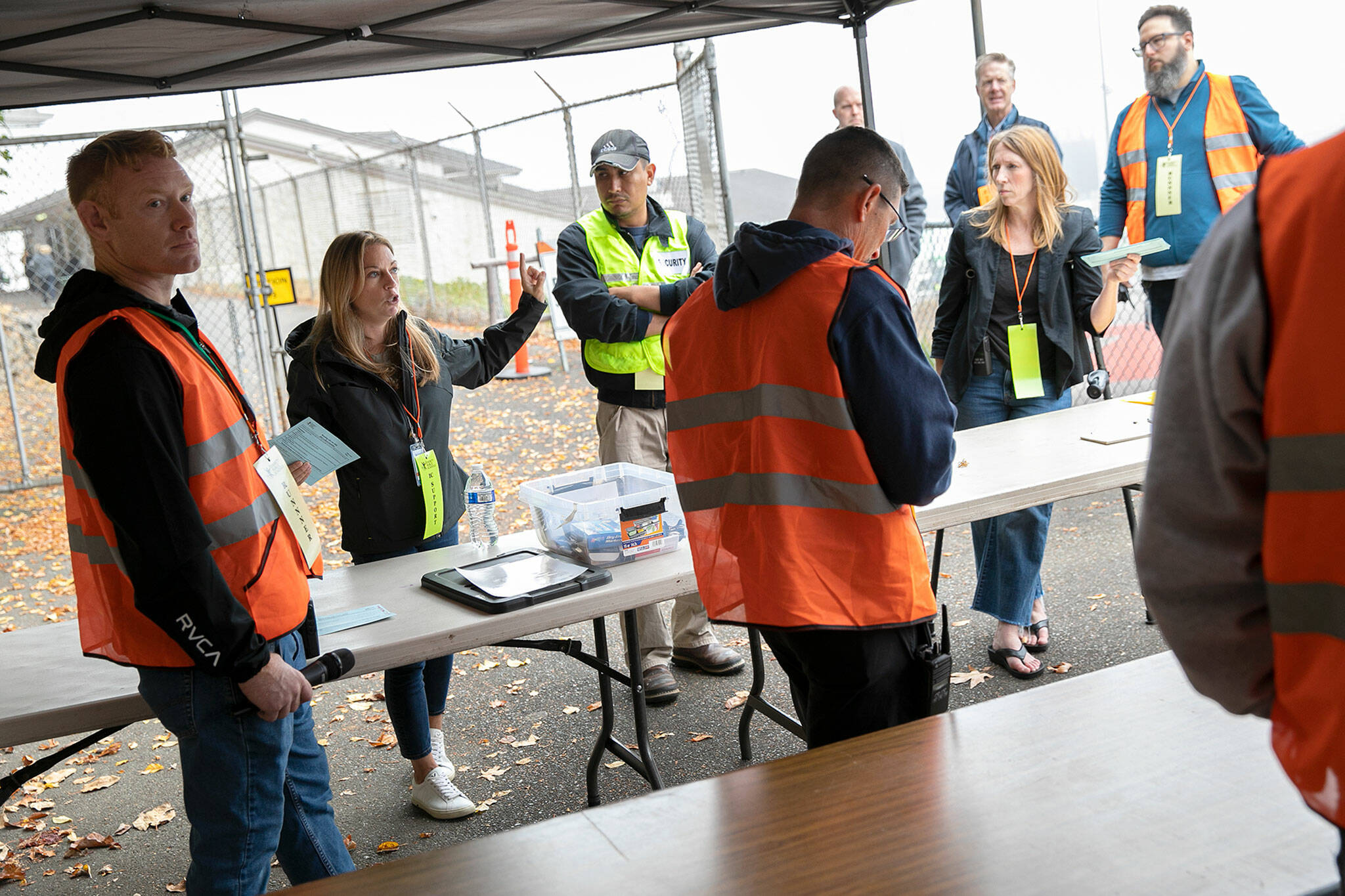 Kristin Shea, second from left, helps keep emergency volunteers from the district informed during an Everett Public Schools emergency drill on Thursday, at Everett Memorial Stadium in Everett. (Ryan Berry / The Herald)