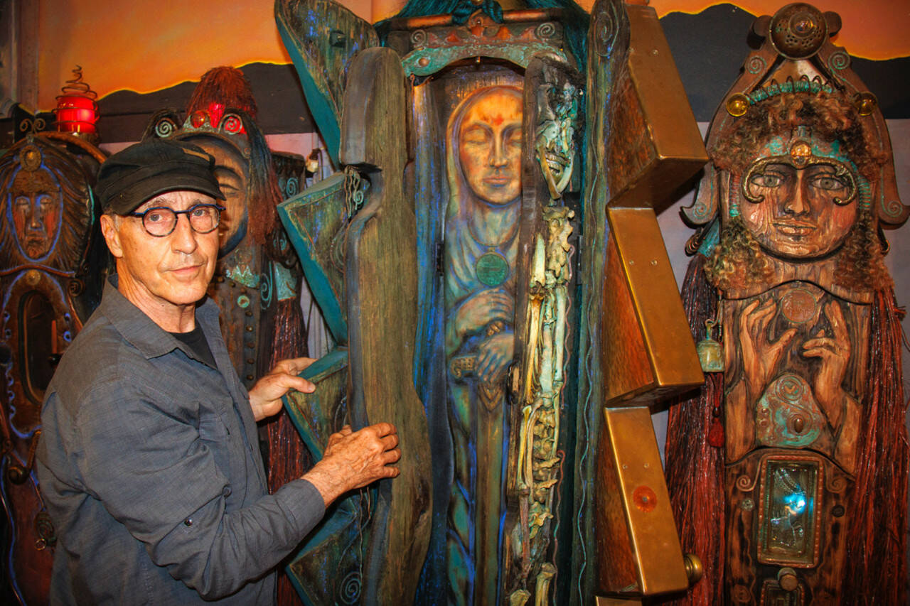 Jerry Wennstrom with “Lightning,” a multi-layered sculpture. Wennstrom’s second body of artistic work consists of several tall, wooden sculptures resembling women that are meant to represent complex themes of birth and death, good and evil, femininity and masculinity. (David Welton)