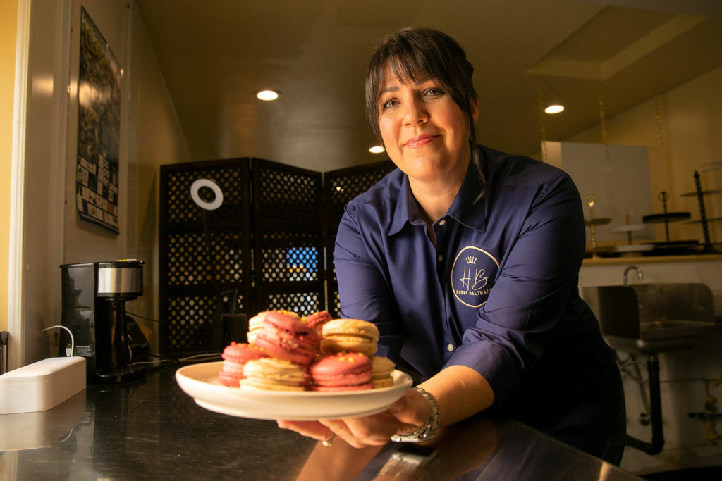 Lisa Laidlaw, owner and baker at House Balthazar, holds a plate of macarons in the kitchen on Oct. 17, at House Balthazar in Monroe. (Ryan Berry / The Herald)

