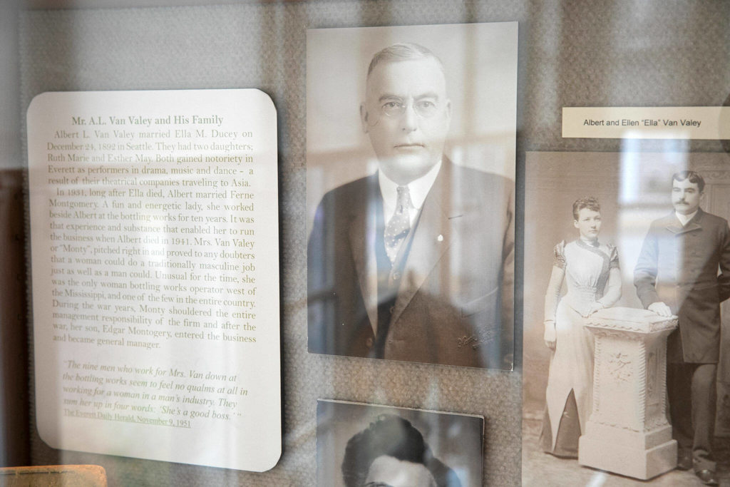 Photos of the Van Valey family are displayed in a glass case in the sunroom of the Van Valey House in Everett. (Ryan Berry / The Herald)
