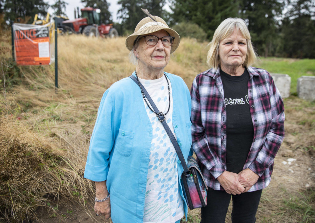 Phyllis Hopkins, left, and Debbie Wetzel at the site of the Cathcart Crossing project on Sept. 22, in Cathcart. Hopkins is one of 13 neighbors left out of the loop about a public hearing and comment period for the proposed development, an appeal alleges. (Olivia Vanni / The Herald)
