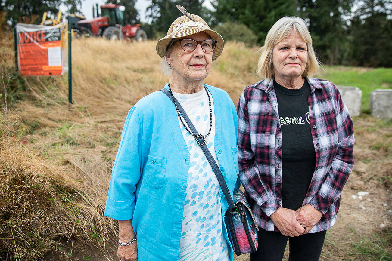 Phyllis Hopkins, left, and Debbie Wetzel at the site of the Cathcart Crossing project on Thursday, Sept. 22, 2022 in Cathcart, Washington. Hopkins is one of 13 neighbors who was left out of the loop about a public hearing and comment period for the proposed development, an appeal alleges. (Olivia Vanni / The Herald)