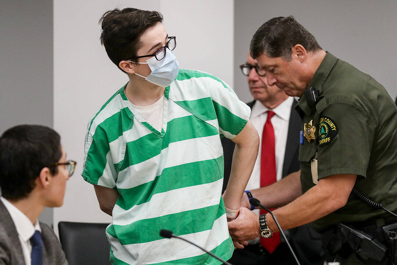 Alexander Fritz is released from handcuffs after being lead into the courtroom Thursday afternoon at Snohomish County Courthouse in Everett, Washington on October 6, 2022.  (Kevin Clark / The Herald)