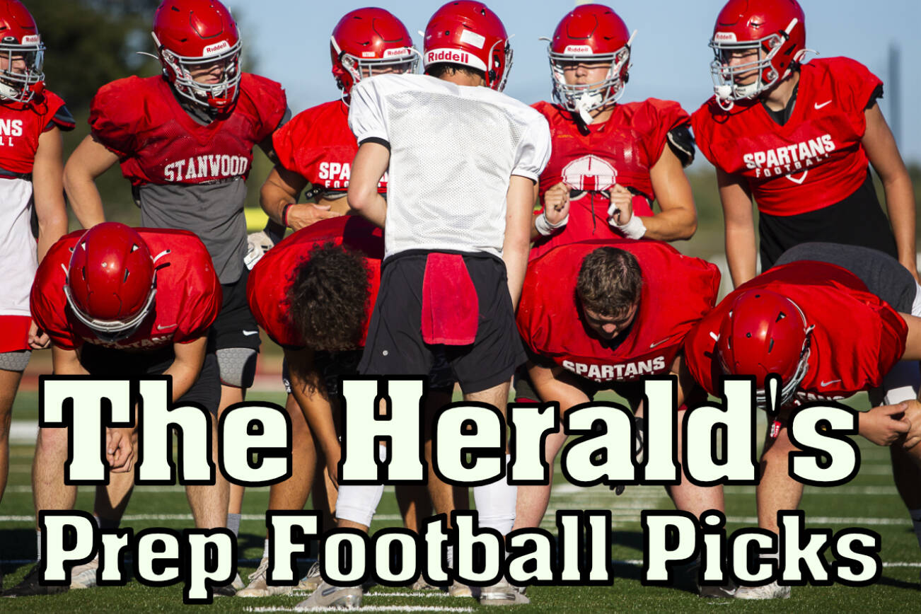 Stanwood's Michael Mascotti relays the next play to his teammates during football practice on Monday, Aug. 29, 2022 in Stanwood, Washington. (Olivia Vanni / The Herald)