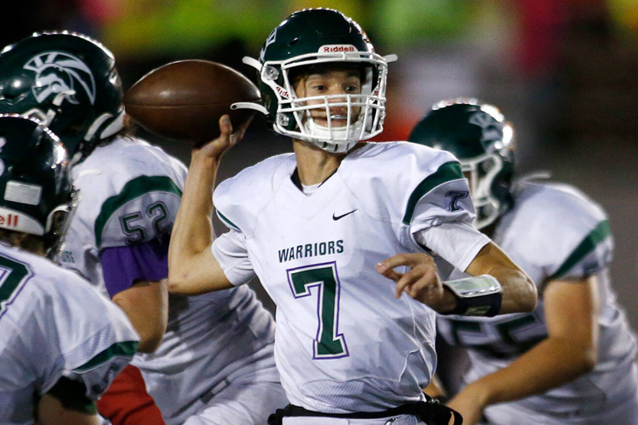 Edmonds-Woodway’s Steven Warren Jr. steps up in the pocket to make a pass against Snohomish on Friday, Sep. 23, 2022, at Snohomish High School in Snohomish, Washington. (Ryan Berry / The Herald)