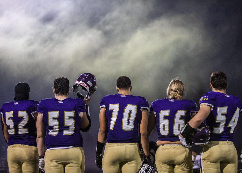 Lake Stevens players line up for the National Anthem before the start of the game against Eastlake on Friday, Oct. 7, 2022 in Lake Stevens, Washington. (Olivia Vanni / The Herald)
