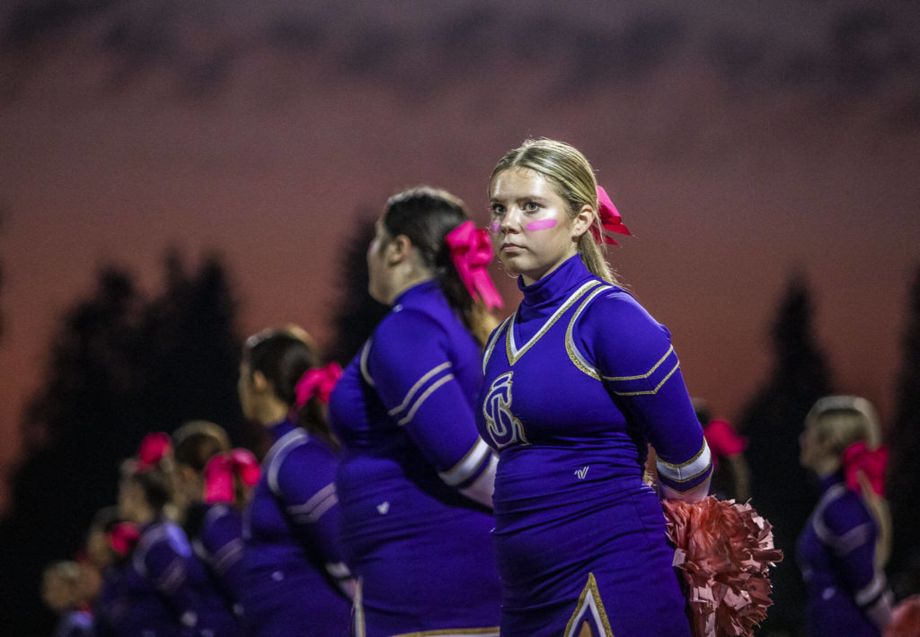 A Lake Stevens cheerleader waits for the start of the game against Eastlake on Friday, Oct. 7, 2022 in Lake Stevens, Washington. (Olivia Vanni / The Herald)
