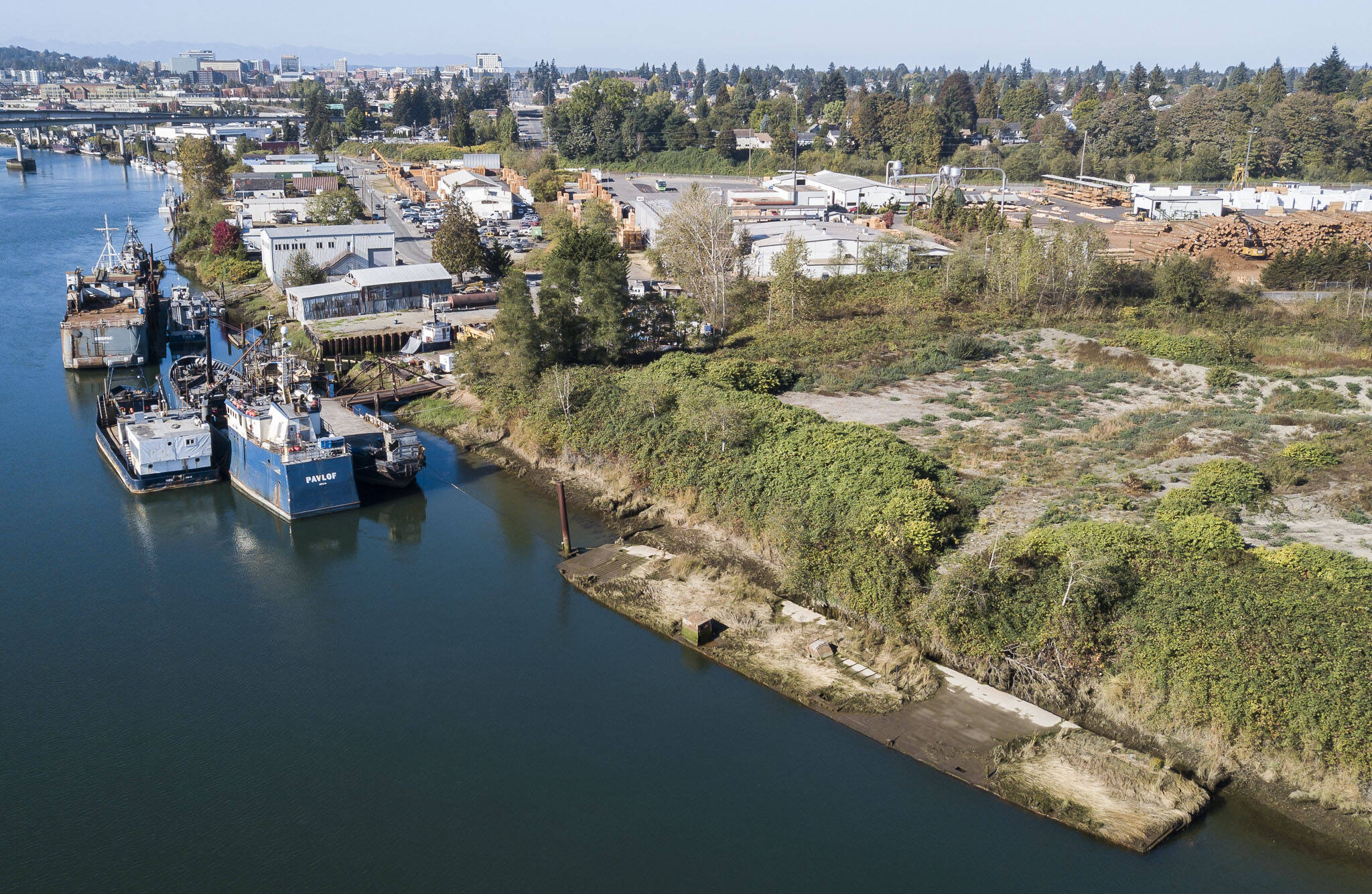 An unknown derelict barge grounded along the bank of the Snohomish River off of Railway Avenue on Tuesday, in Everett. (Olivia Vanni / The Herald)