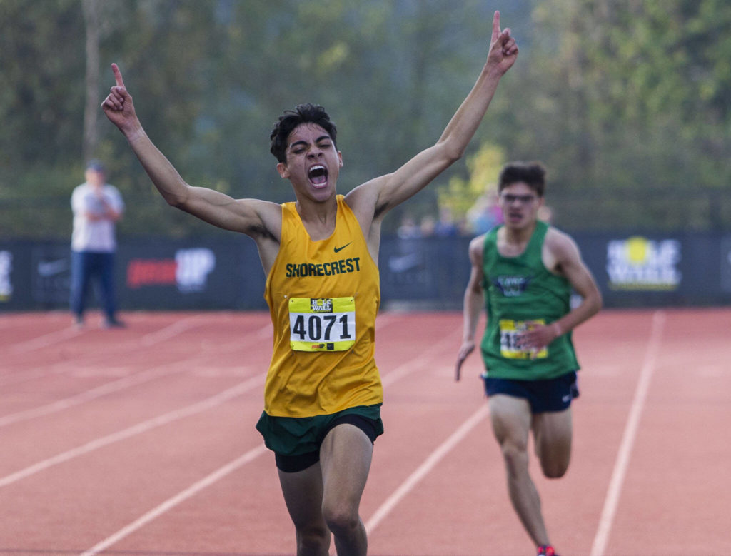 Shorecrest senior George Fernandez celebrates as he crosses the line to win the boys silver race. (Olivia Vanni / The Herald)
