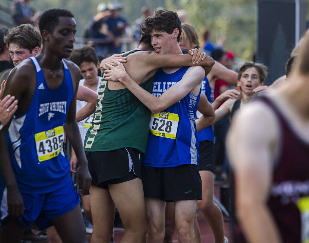 Runners hug after finishing their race at the Hole In The Wall Invitational on Saturday, Oct. 8, 2022 in Arlington, Washington. (Olivia Vanni / The Herald)
