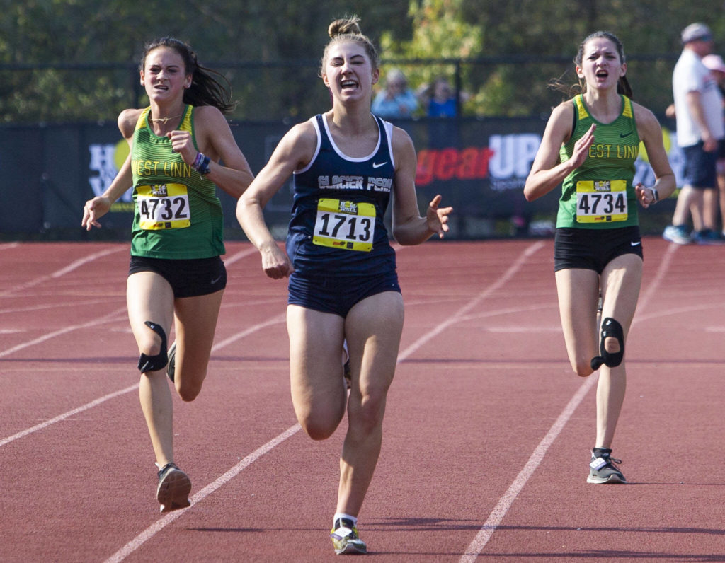 Glacier Peak’s Clara Diepenbrock grimaces as she runs toward the finish line at the Hole In The Wall Invitational on Saturday, Oct. 8, 2022 in Arlington, Washington. (Olivia Vanni / The Herald)
