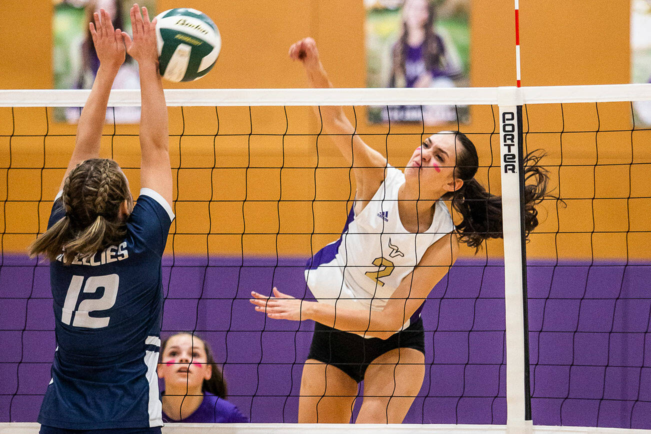 Lake Stevens’ Bella Christensen spikes the ball past Glacier Peak’s Julia Martin during the match on Tuesday, Oct. 11, 2022 in Lake Stevens, Washington. (Olivia Vanni / The Herald)