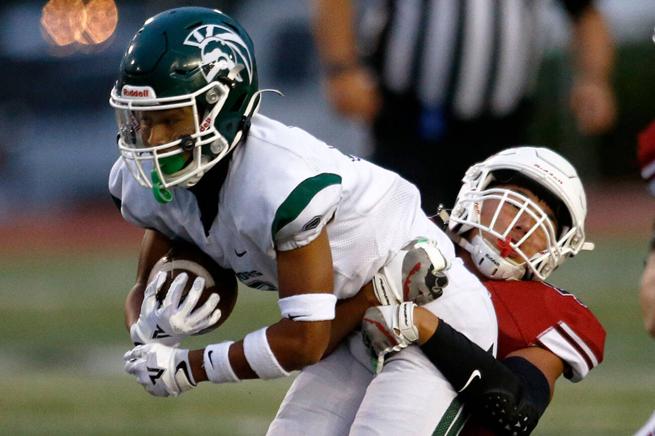 Edmonds-Woodway’s Jesse Hart gets taken down behind the line of scrimmage against Snohomish on Friday, Sep. 23, 2022, at Snohomish High School in Snohomish, Washington. (Ryan Berry / The Herald)