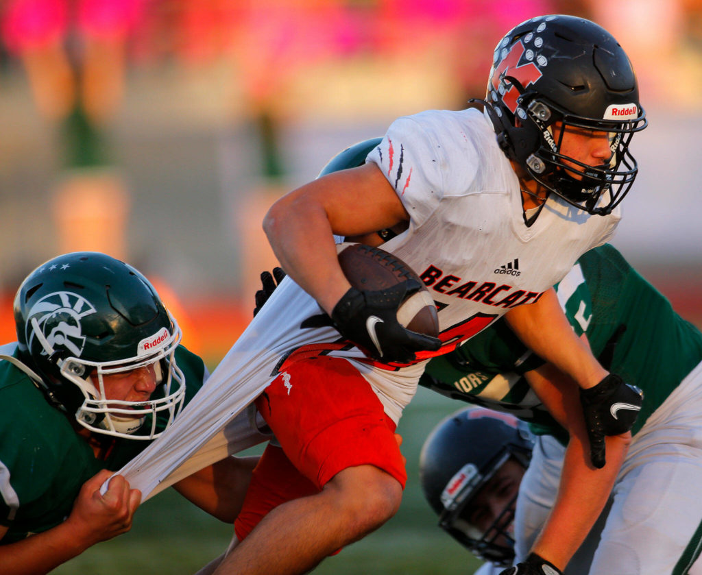 Monroe’s Beau Pruett gets pulled down by multiple defenders while fighting for extra yards against Edmonds-Woodway on Friday, Oct. 14, 2022, at Edmonds School District Stadium in Edmonds, Washington. (Ryan Berry / The Herald)
