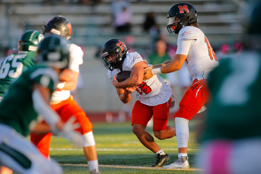 Monroe’s Beau Pruett takes a handoff against Edmonds-Woodway on Friday, Oct. 14, 2022, at Edmonds School District Stadium in Edmonds, Washington. (Ryan Berry / The Herald)
