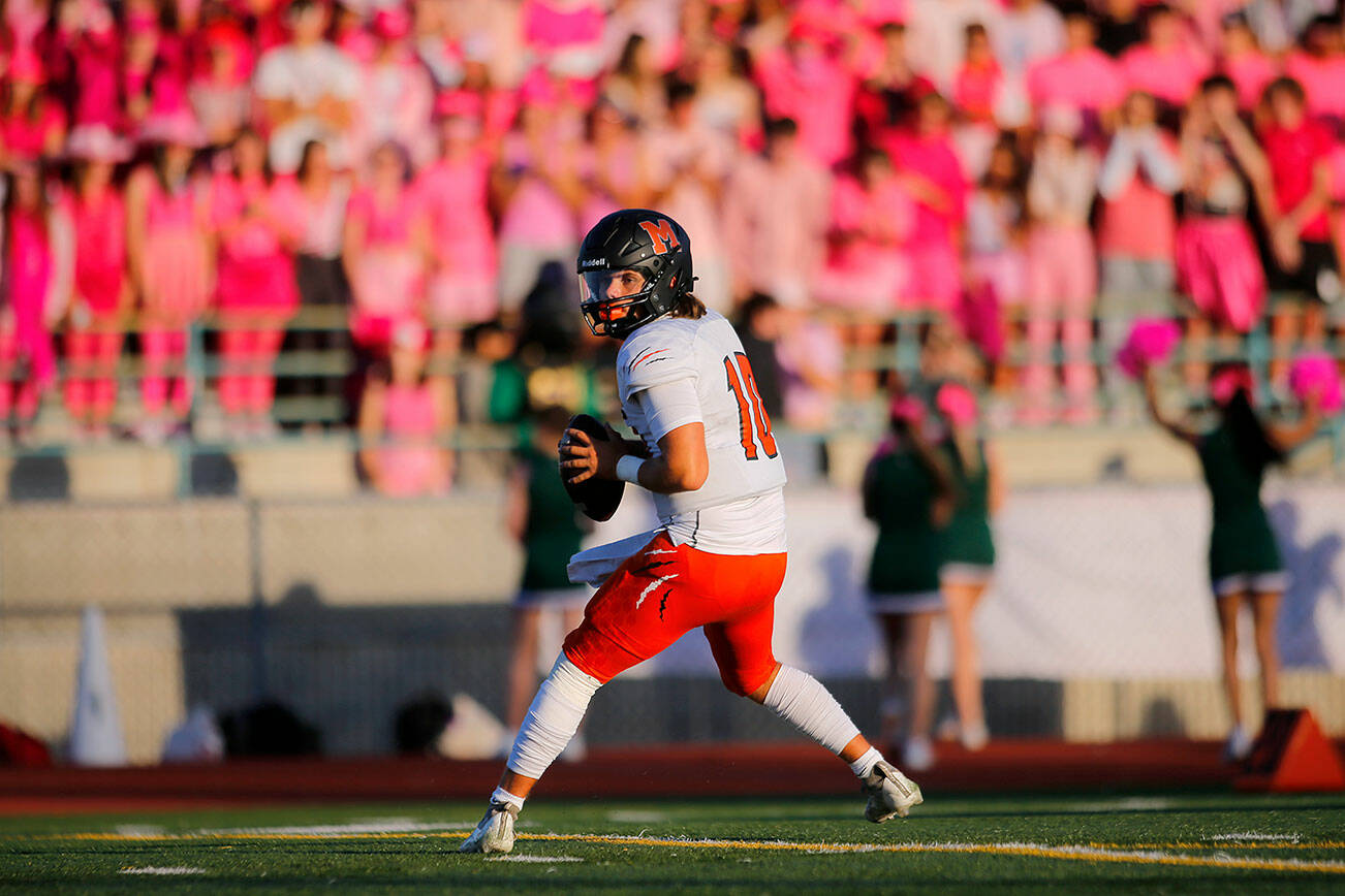 Monroe’s Blake Springer drops back and surveys the field against Edmonds-Woodway on Friday, Oct. 14, 2022, at Edmonds School District Stadium in Edmonds, Washington. (Ryan Berry / The Herald)