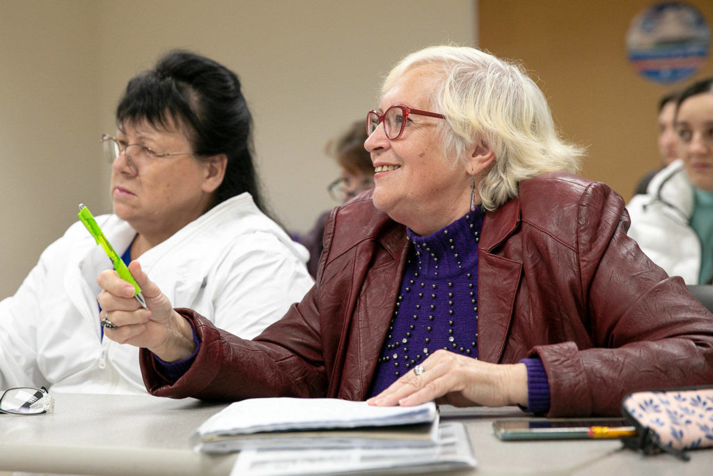 Student Liudmilea answers a question from ESL teacher James Willcox in one of his classes at Everett Community College on Monday, in Everett. (Ryan Berry / The Herald)

