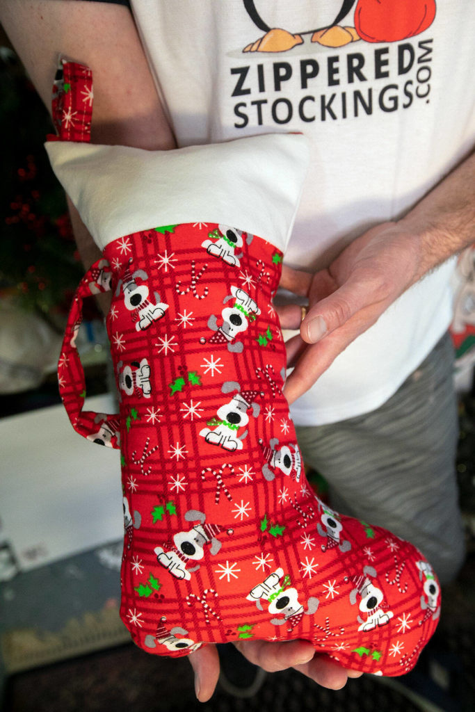 Alex Phillips holds a Zippered Stocking. (Ryan Berry / The Herald)
