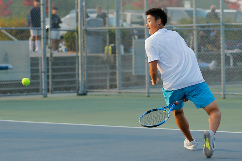 Jackson High sophomore Ben Lee hits a tweener back over the net against senior teammate Austen Lim during the 4A District 1 Singles Championship Tuesday, Oct. 18, 2022, at Glacier Peak High School in Snohomish, Washington. (Ryan Berry / The Herald)

