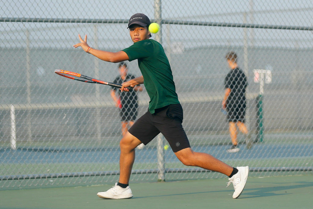 Jackson High senior Austen Lim returns a ball against sophomore teammate Ben Lee during the 4A District 1 Singles Championship Tuesday, Oct. 18, 2022, at Glacier Peak High School in Snohomish, Washington. (Ryan Berry / The Herald)
