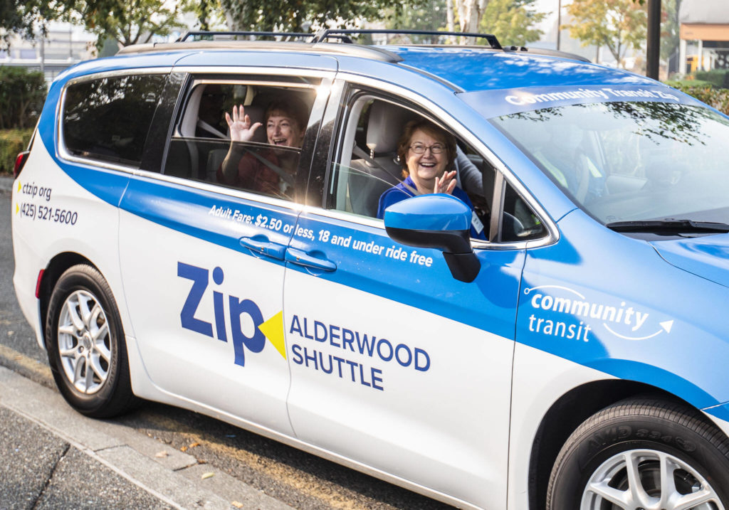 Lynnwood Mayor Christine Frizzell and Community Transit leaders take the inaugural ride in the Zip Alderwood shuttle at the launch event Wednesday in Lynnwood. (Olivia Vanni / The Herald)
