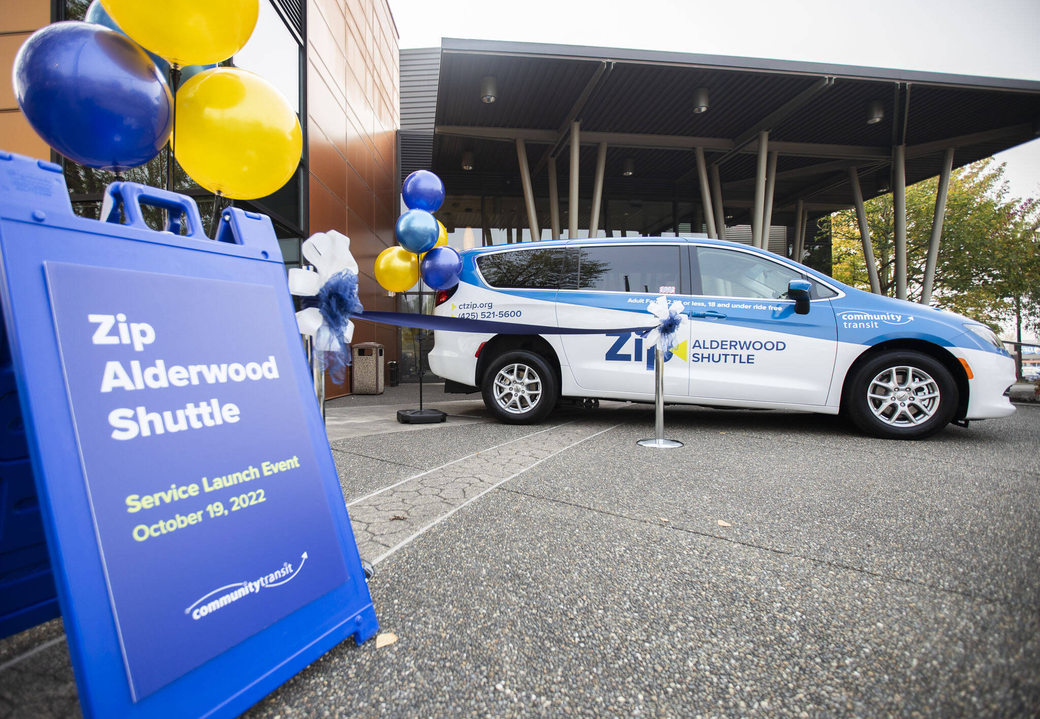 Riders can hail a sedan or a van, as seen here Wednesday at the Lynnwood Convention Center, through the new Community Transit Zip Alderwood shuttle service. One of the vans is wheelchair accessible. (Olivia Vanni / The Herald)