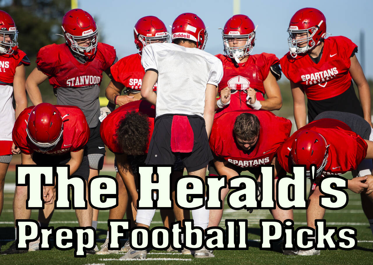 Stanwood's Michael Mascotti relays the next play to his teammates during football practice on Monday, Aug. 29, 2022 in Stanwood, Washington. (Olivia Vanni / The Herald)
