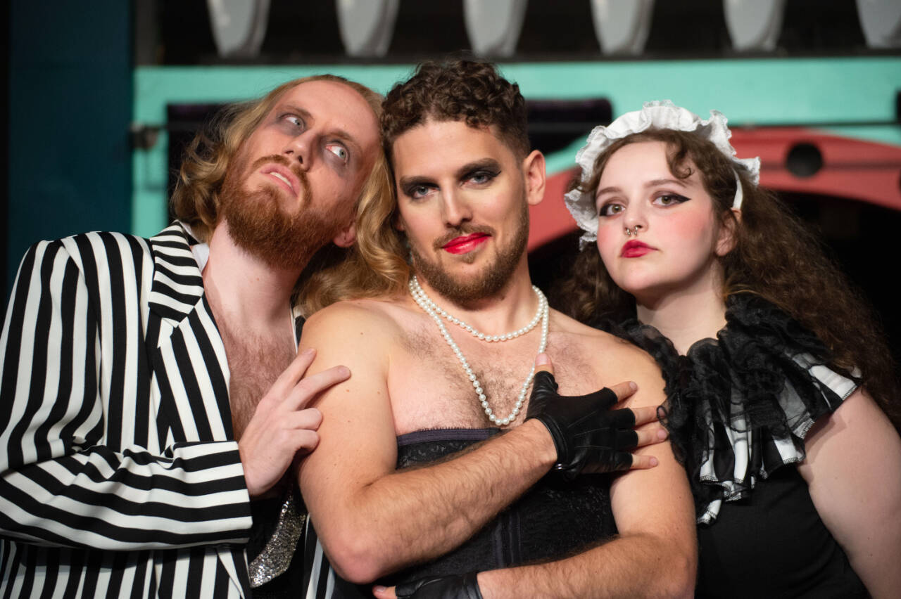 Handyman Riff Raff (Kendall Collins), mad scientist Dr. Frank-N-Furter (Josiah Miller) and crazed domestic Magenta (Lauren Hayes) host unsuspecting guests in “The Rocky Horror Show” at the Red Curtain Arts Center in Marysville. (Kenny Randall)