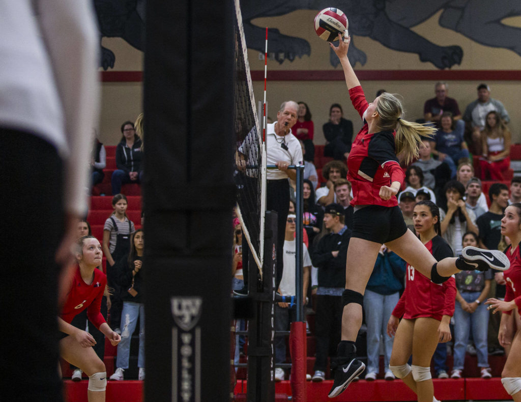Snohomish’s Reagan Bullock tips the ball over the net during the match against Archbishop Murphy on Wednesday, Oct. 19, 2022 in Snohomish, Washington. (Olivia Vanni / The Herald)
