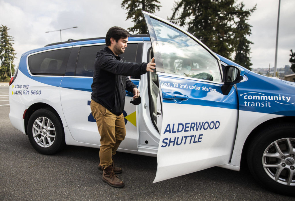 Street Smarts columnist Ben Watanabe steps into the new Zip Alderwood Shuttle on Sunday in Lynnwood. (Olivia Vanni / The Herald)
