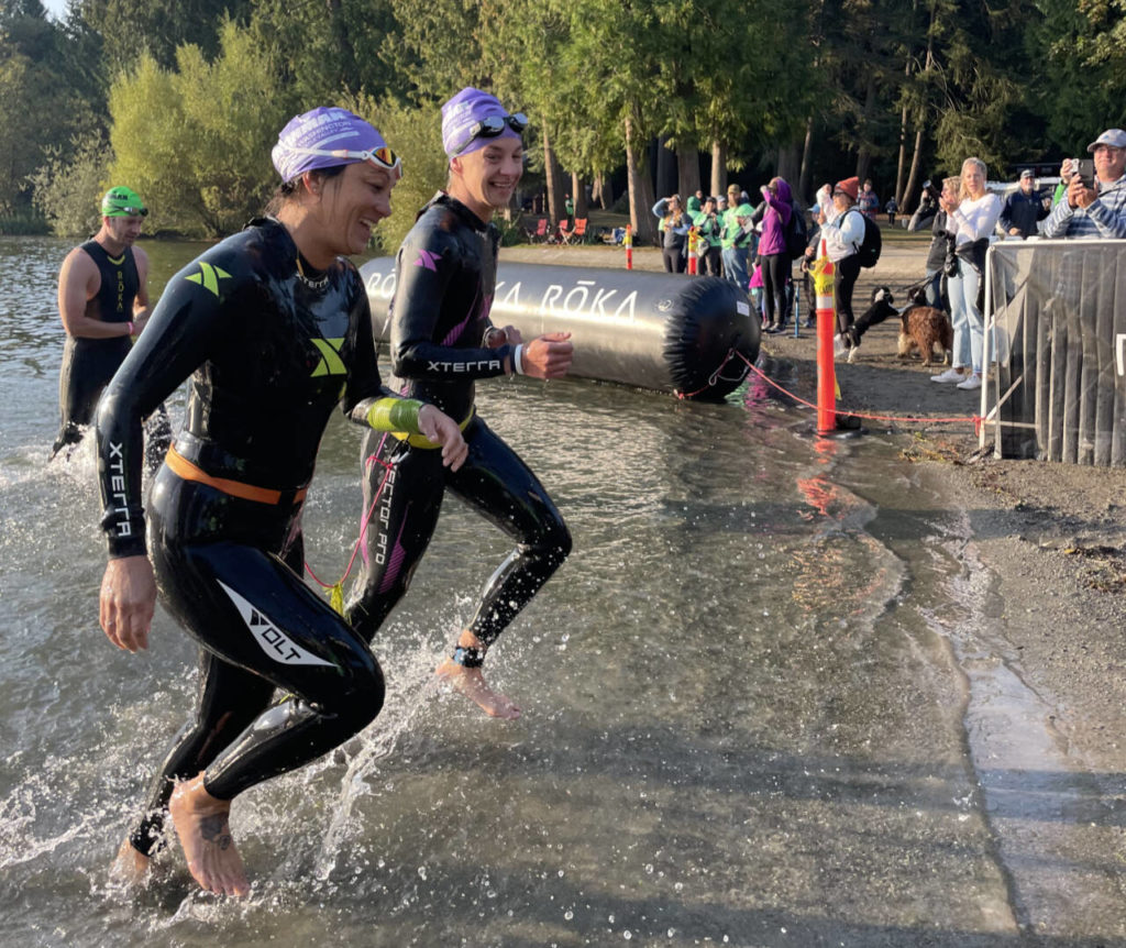 Misty Johnson (right) is tethered to her guide, Amy Lewandowski, during in the Ironman 70.3 Washington half-ironman triathlon last month in Maple Valley. (Photo provided by Andrea Skorheim)

