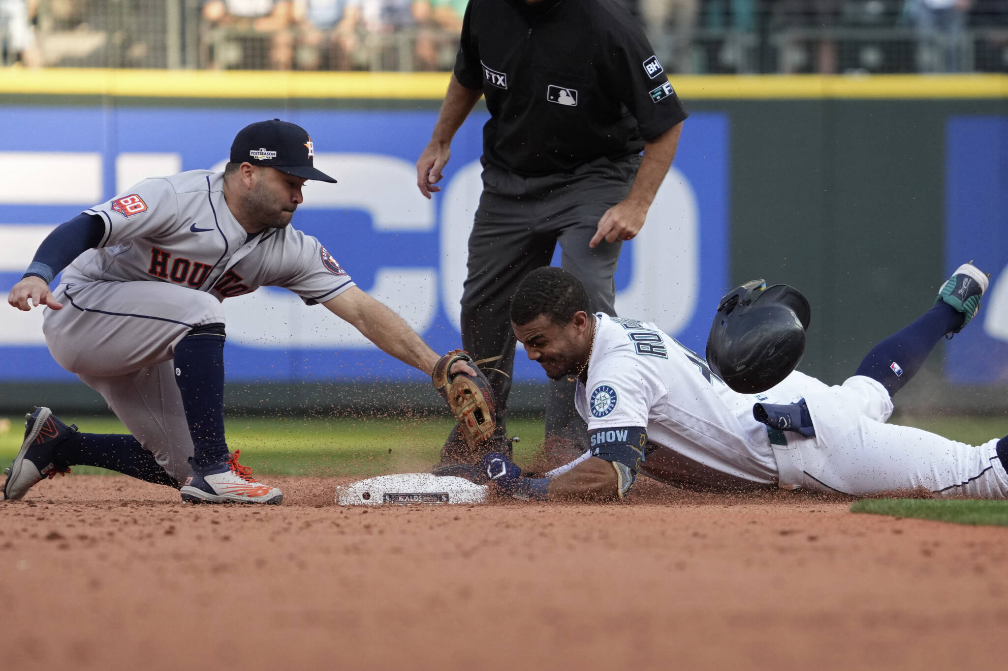 The Mariners’ Julio Rodriguez (44) slides safely into second base for a double under Astros second baseman Jose Altuve during the eighth inning in Game 3 of an American League Division Series playoff game on Oct. 15 in Seattle. (AP Photo/Ted S. Warren)
