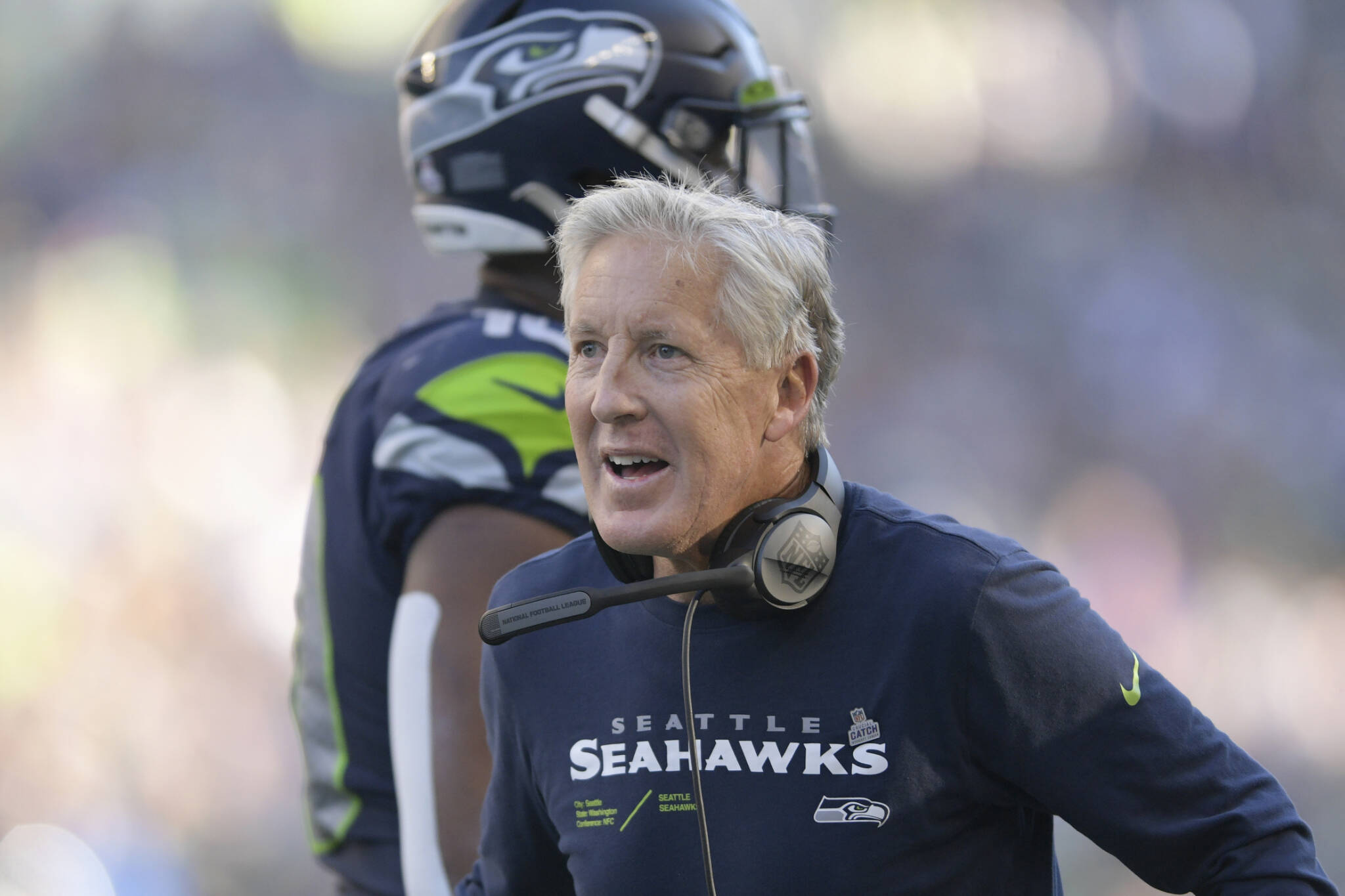 Seattle Seahawks head coach Pete Carroll greets players during the second half of his team's NFL football game against the Arizona Cardinals in Seattle, Sunday, Oct. 16, 2022. (AP Photo/Caean Couto)