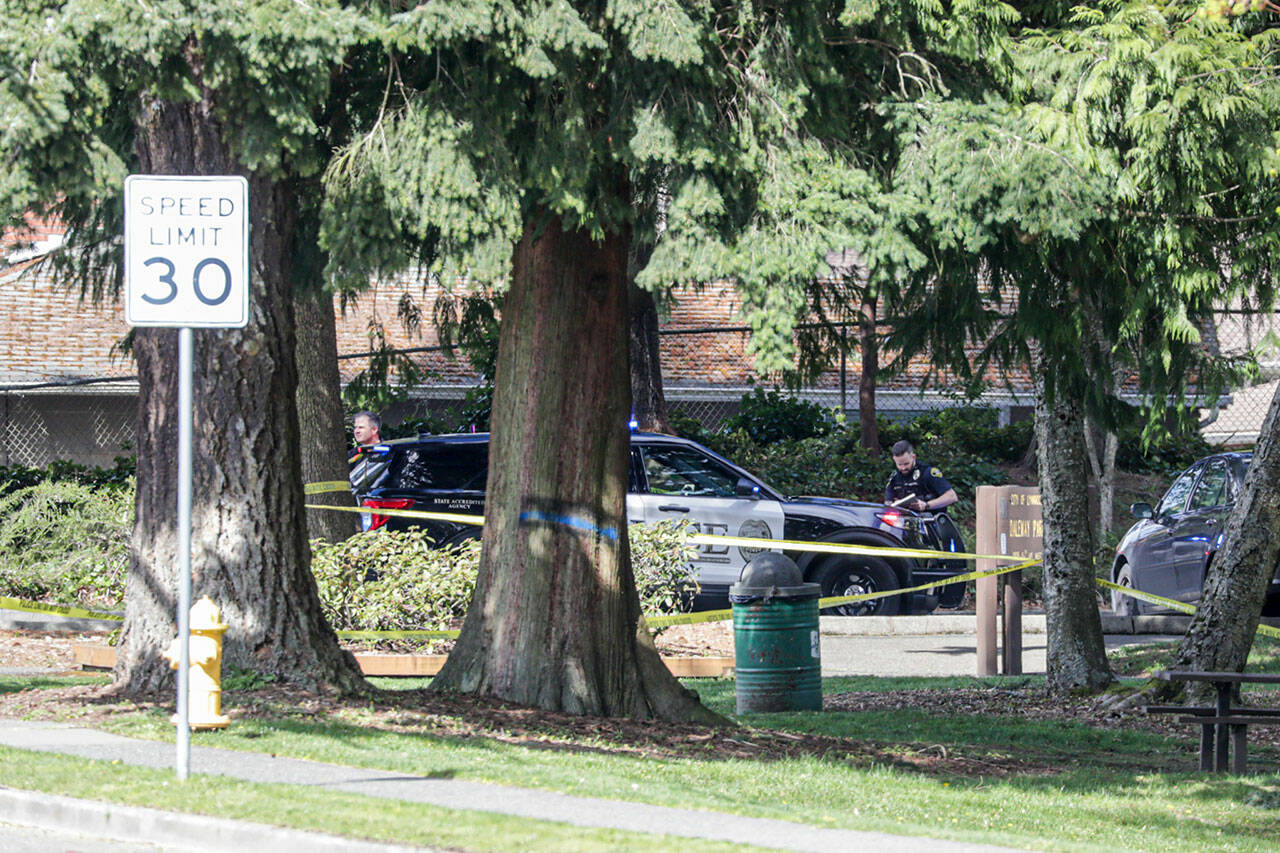 Police officials investigate a shooting at Daleway Park on April 5, in Lynnwood. (Kevin Clark / The Herald)