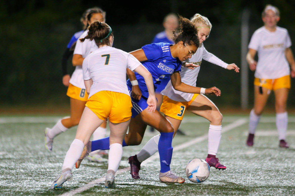 Shorewood’s Diana Tuilevuka splits two defenders while trying to attack against Shorecrest on Monday, Oct. 24, 2022, at Shoreline Stadium in Shoreline (Ryan Berry / The Herald)
