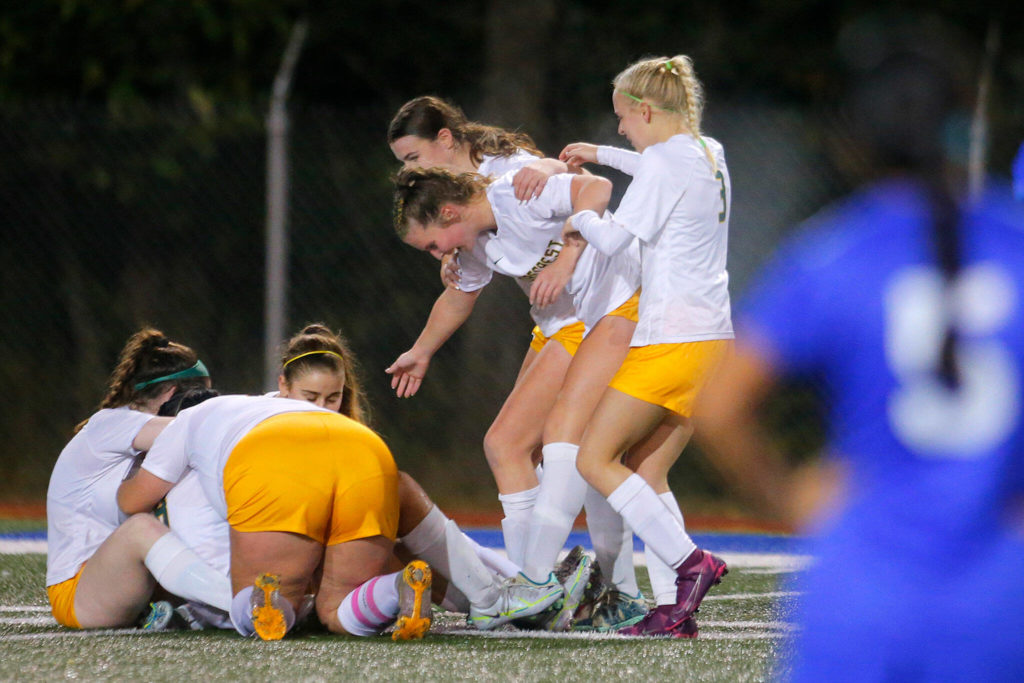 The Shorecrest girls dogpile after holding off Shorewood for a 1-1 draw on Monday, Oct. 24, 2022, at Shoreline Stadium in Shoreline (Ryan Berry / The Herald)

