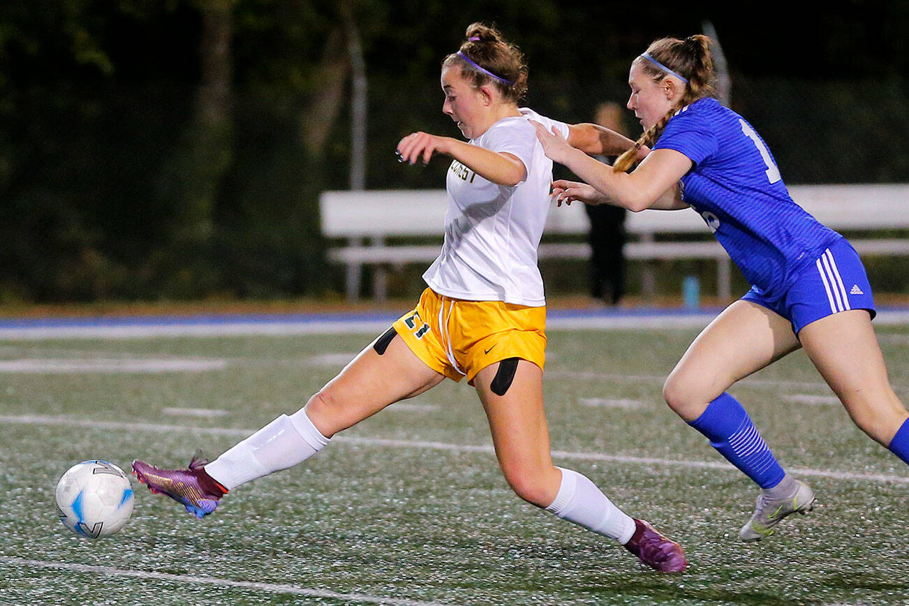 Shorecrest’s Esmerelda Fogg sends a ball away while being pressured against Shorewood on Monday, Oct. 24, 2022, at Shoreline Stadium in Shoreline (Ryan Berry / The Herald)