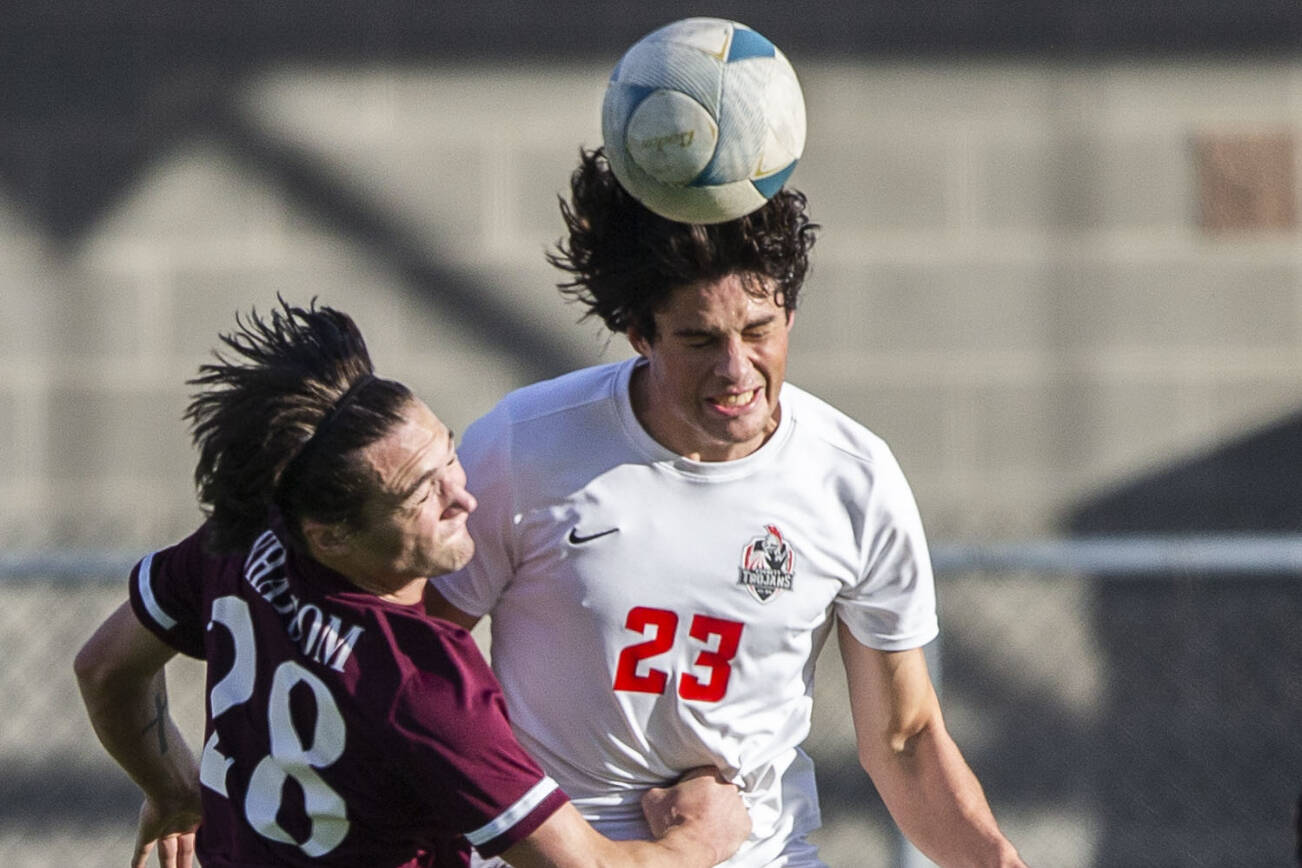 Everett’s River Stewart grimaces from being punched in the stomach while jumping up for a header during the game against Whatcom on Sunday, Oct. 23, 2022 in Everett, Washington. (Olivia Vanni / The Herald)