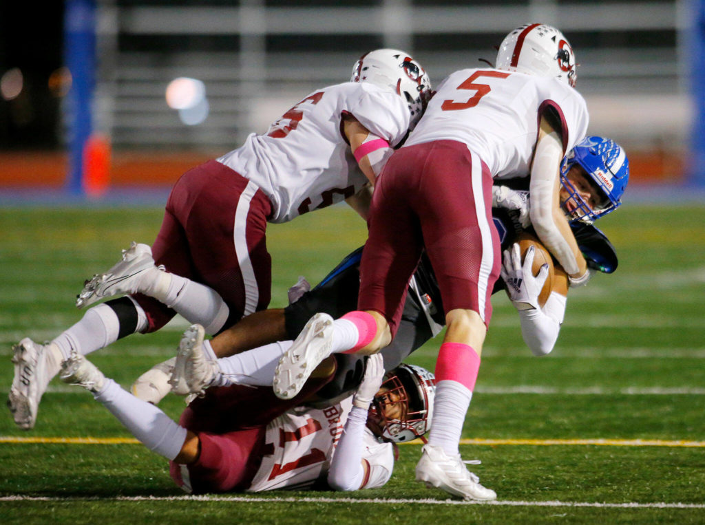 Shorewood’s Alberto Solano gets taken down by a gang of Cascade defenders on Wednesday, Oct. 26, 2022, at Shoreline Stadium in Shoreline, Washington. (Ryan Berry / The Herald)
