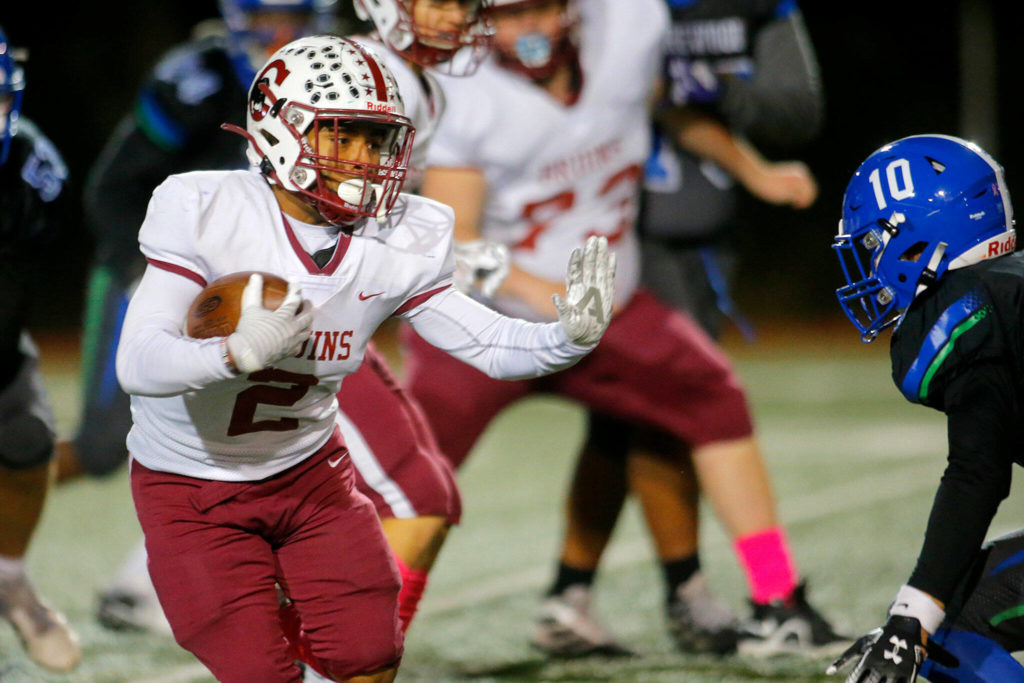 Cascade’s Julian Thomas prepares to stiff arm a defender against Shorewood on Wednesday, Oct. 26, 2022, at Shoreline Stadium in Shoreline, Washington. (Ryan Berry / The Herald)
