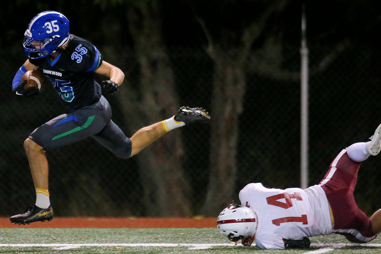 Shorewood’s Grant Harley slips the last defender on his way to the end zone on a long touchdown run against Cascade on Wednesday, Oct. 26, 2022, at Shoreline Stadium in Shoreline, Washington. (Ryan Berry / The Herald)